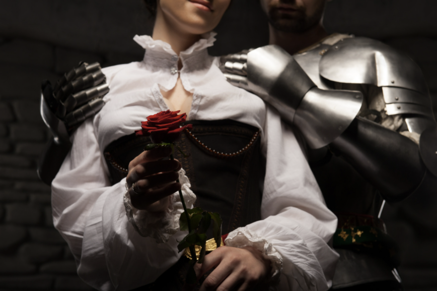 Woman holding a rose with a knight in armor.